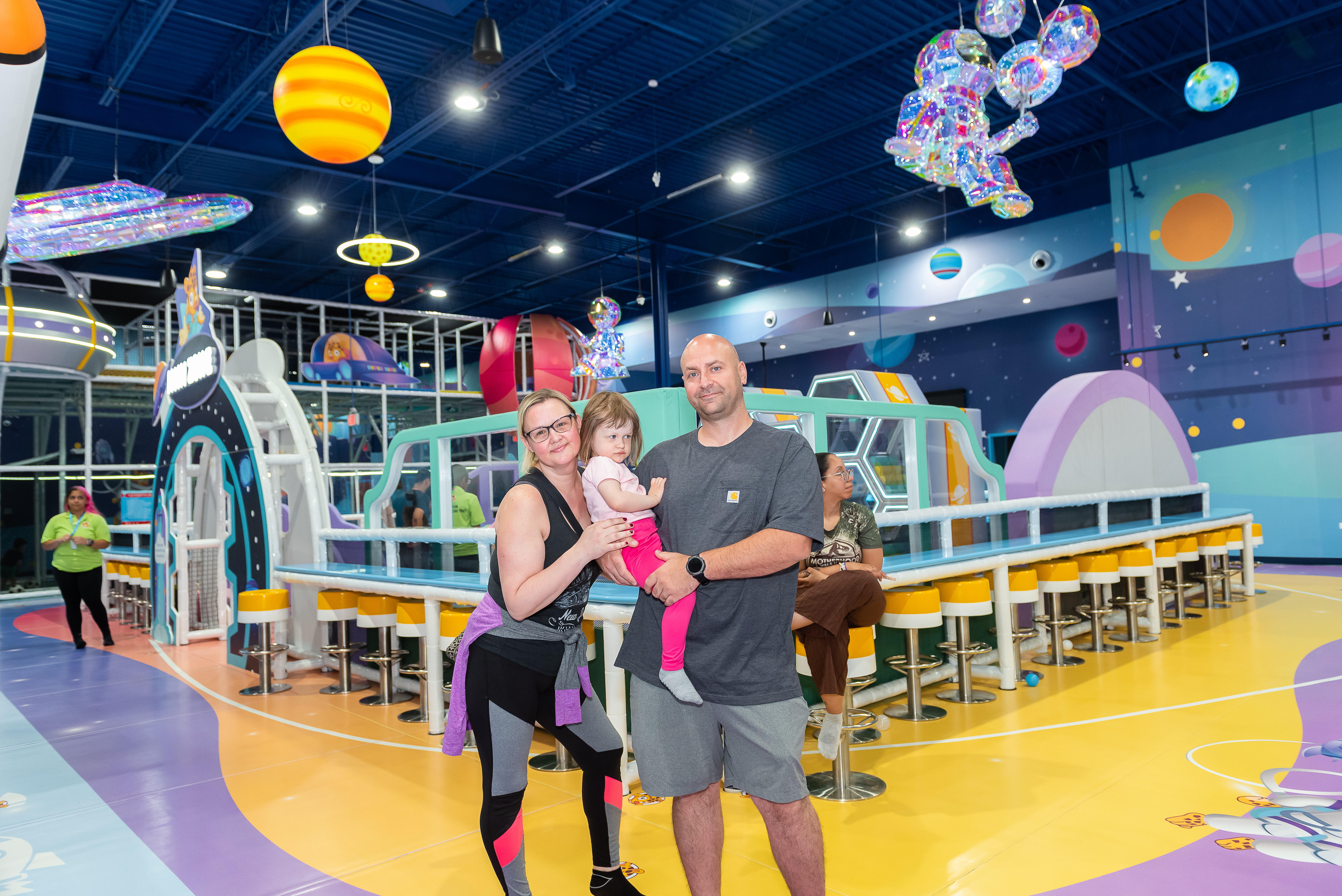 Parents holding their toddler at a Hyper Kidz birthday party